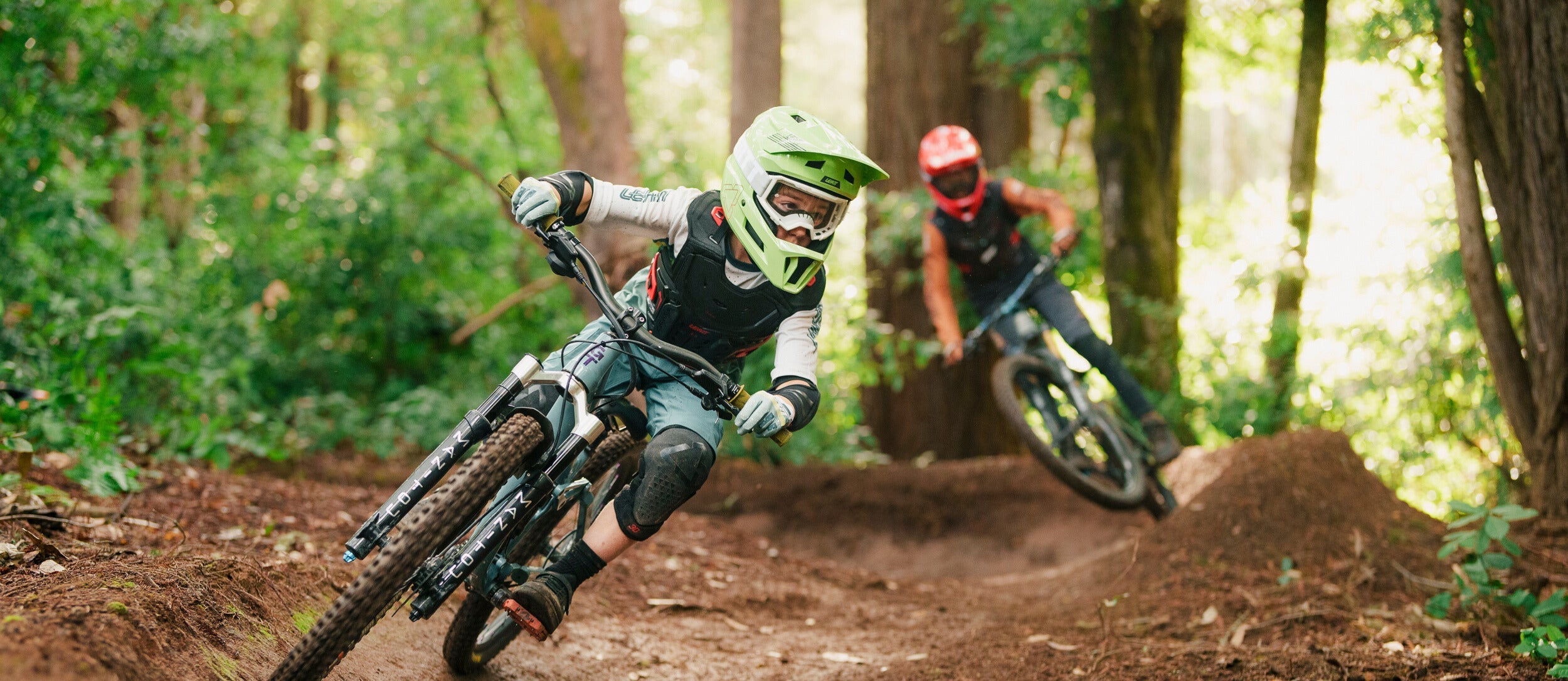 Young riders on MTB bikes in a dirt road.
