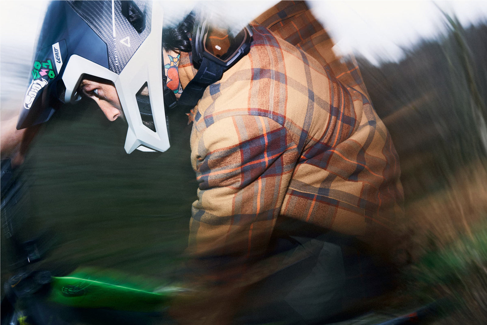 Rider wearing Leatt Helmet Gravity 5.0 and a plaid jacket.